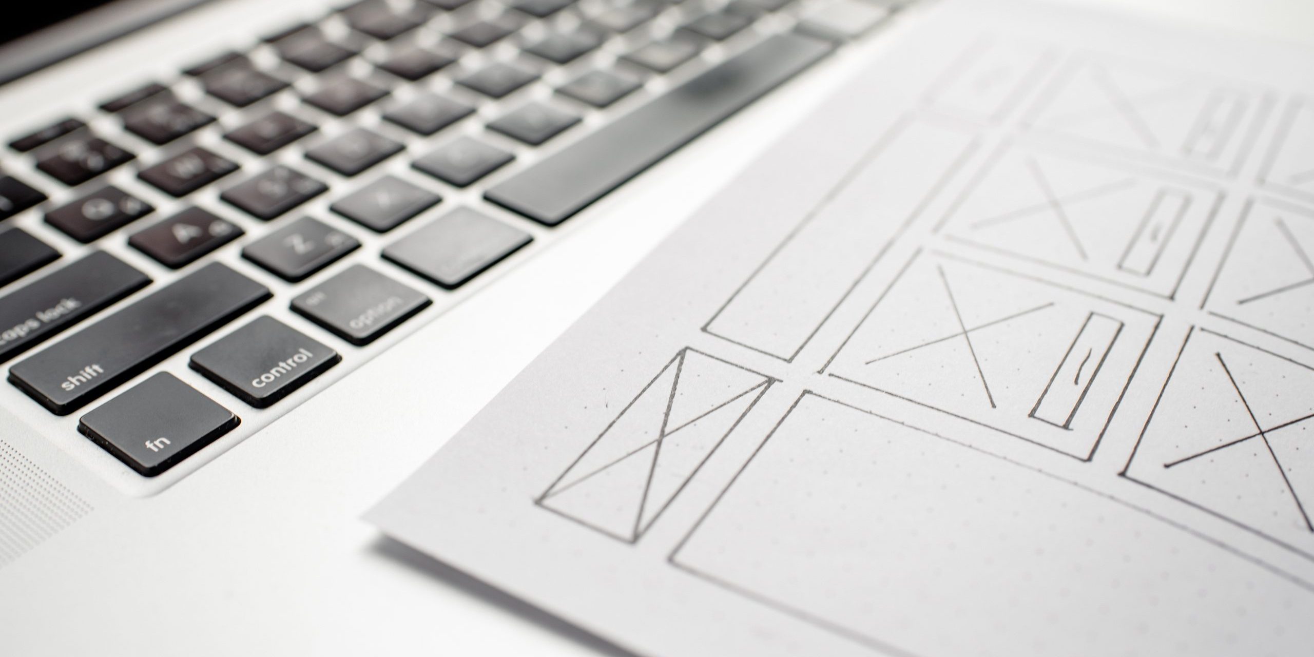 UX website designer drawing wireframe sketch of prototype, frame